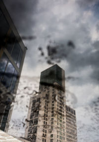 Low angle view of building against cloudy sky