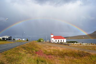 Scenic view of rainbow over church against sky