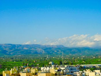 Cityscape with mountain range in background