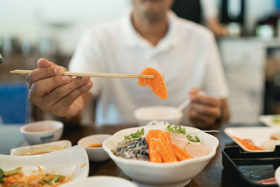 Midsection of man preparing food in restaurant