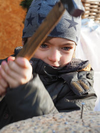 Boy hammering nail on wood