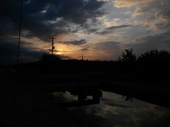 Scenic view of sea against cloudy sky at sunset