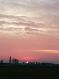 Scenic view of field against sky during sunset