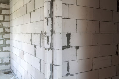 Walls under construction of foam blocks in walls of country house