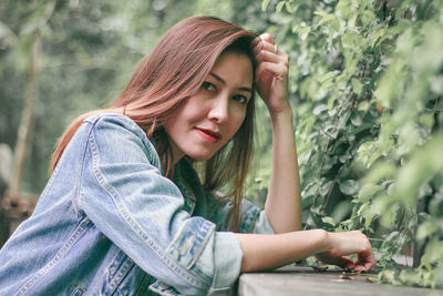 Side view portrait of beautiful woman by plants