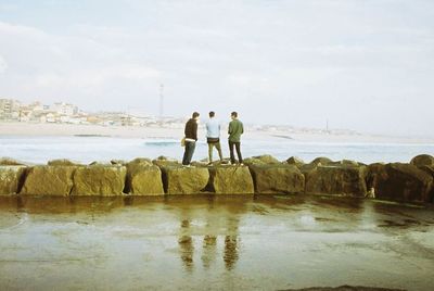 Rear view of man standing on beach