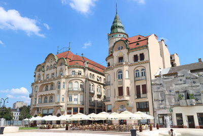 Low angle view of buildings against blue sky