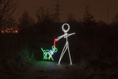 Illuminated light painting on wall at night