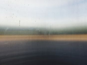 Full frame shot of wet glass window in rainy season