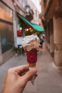 Cropped hand holding ice cream cone