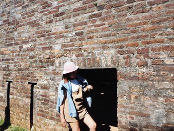 Woman standing against wall