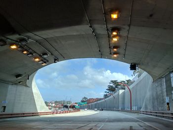 Illuminated road against sky in city