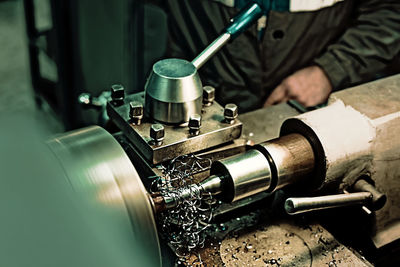 Midsection of man working at factory