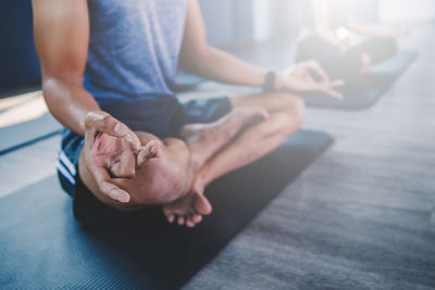 Low section of man sitting on floor