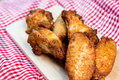Roasted chicken wings on cutting board