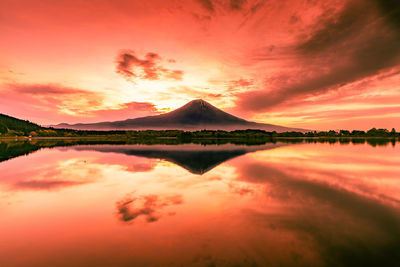 Scenic view of lake against romantic sky at sunset