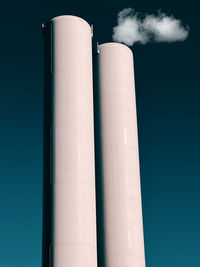 Low angle view of smoke stack against sky