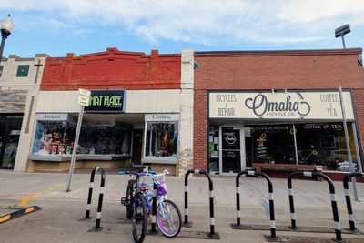 Bicycles on store in city against sky