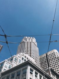 Low angle view of buildings against blue sky