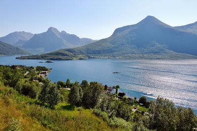 Scenic view of lake and mountains against clear sky