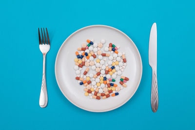 Directly above shot of food on table against blue background