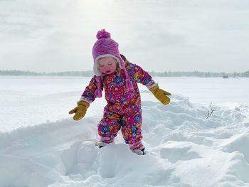 Girl in snow on field during winter