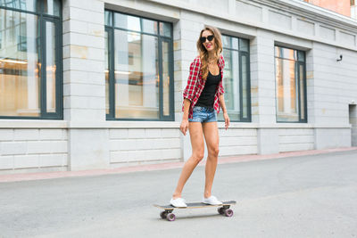 Woman skateboarding outdoors