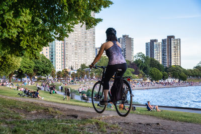 Woman riding bicycle on city street