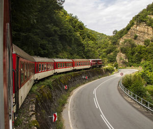 Train by street against sky