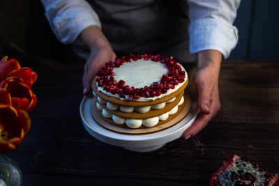 Midsection of man holding cake