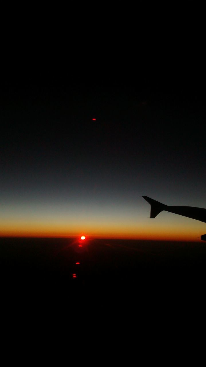 flying, airplane, air vehicle, transportation, sunset, mode of transport, mid-air, aircraft wing, scenics, sky, beauty in nature, travel, silhouette, copy space, sea, journey, part of, tranquil scene, nature, orange color