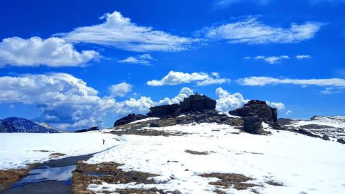 Scenic view of snowcapped mountains against blue sky