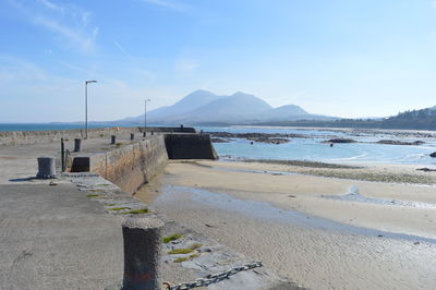 Scenic view of beach against blue sky