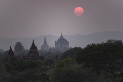 Panoramic view of temple against sky at sunset