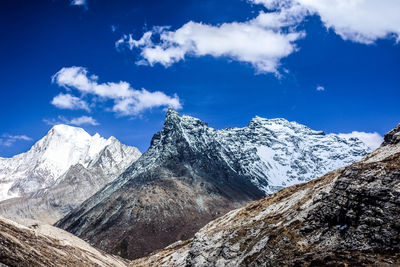 Scenic view of snowcapped mountain against blue sky