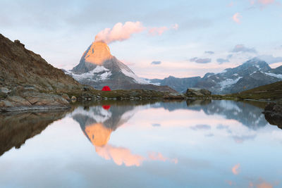 Scenic view of lake and mountains against sky