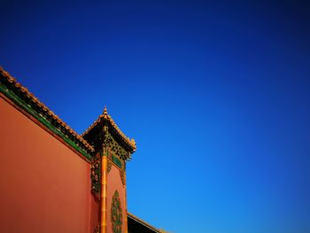 Low angle view of traditional building against clear blue sky