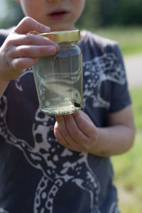 Close-up of boy holding bottle