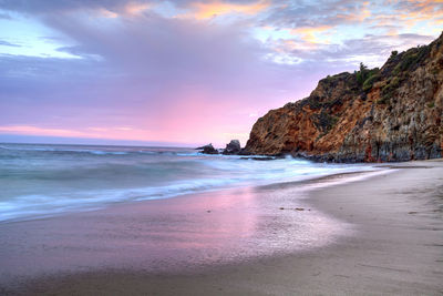 Scenic view of beach at sunset