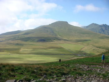 Scenic view of golf course on field against sky