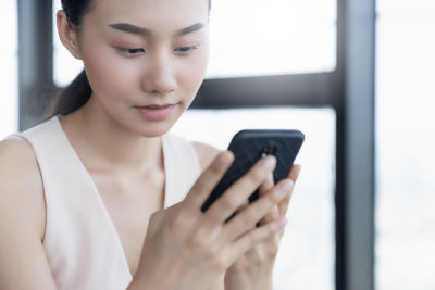 Midsection of woman using mobile phone