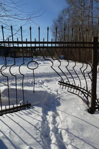 Snow covered railing against sky