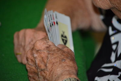 Senior woman playing cards at table