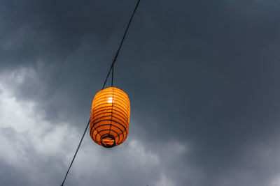 Low angle view of illuminated lantern against sky