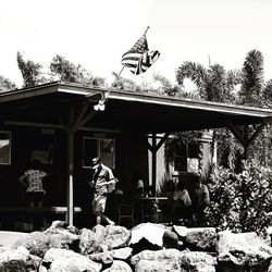 People standing by rocks against building