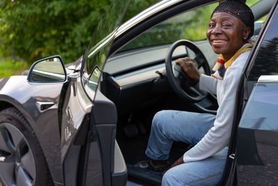 Portrait of woman sitting in car