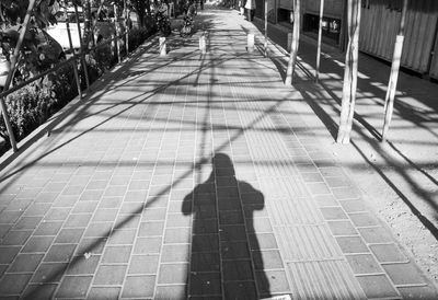 Shadow of man on footpath