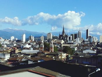 Cityscape against cloudy sky