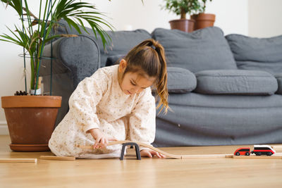 Cute girl playing with toy at home