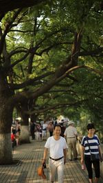 Happy people walking on footpath in city